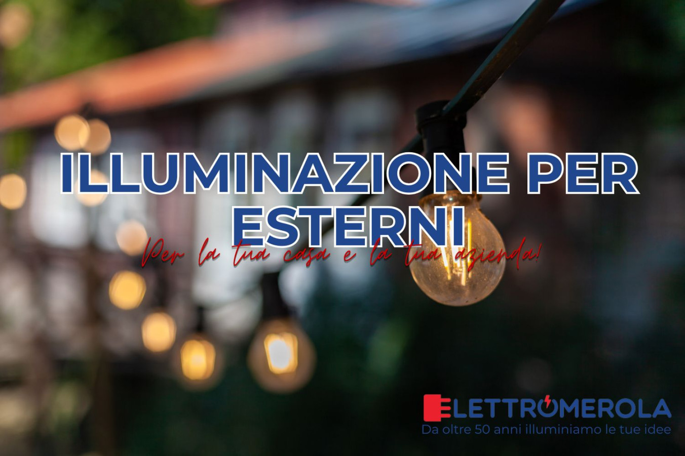 lampadina calda in un ambiente esterno come quello di un guardino. Sullo sfondo una abitazione in mattoni.